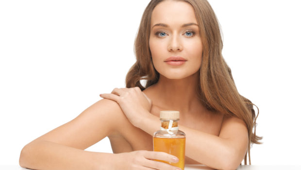 picture-of-beautiful-woman-with-oil-bottle-128006885.jpg